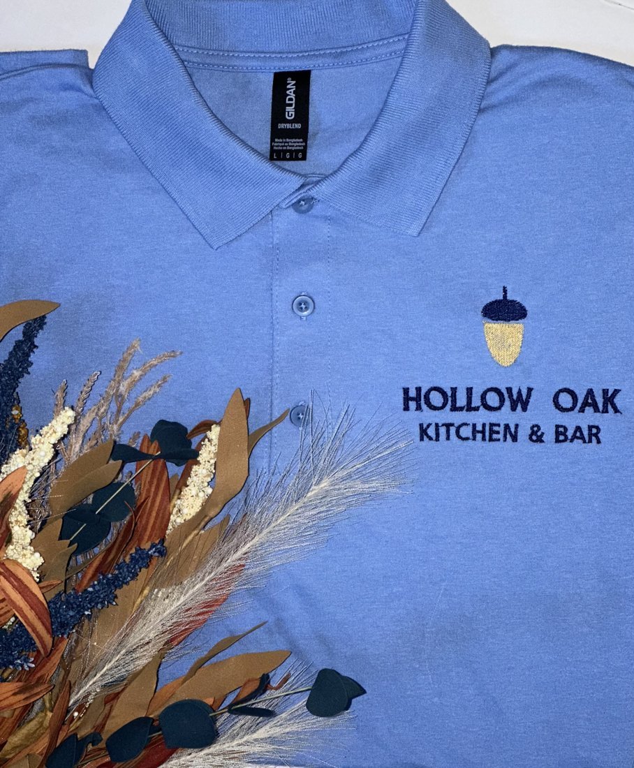 Light blue polo embroidered with a restaurant logo